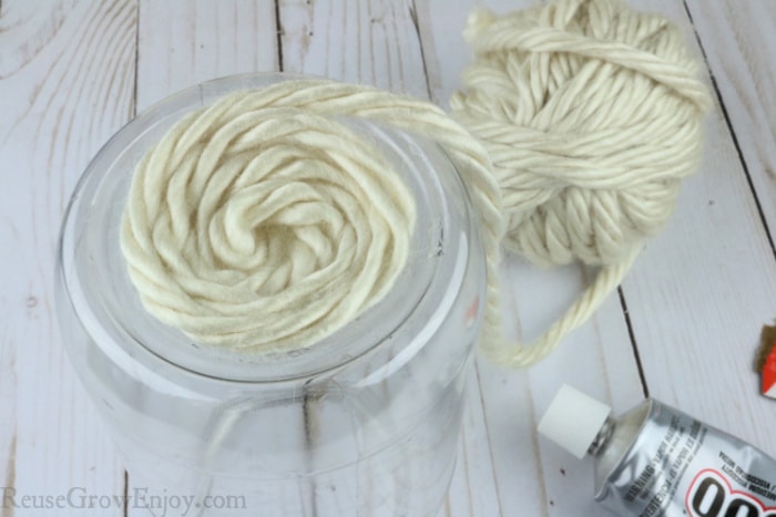 Wrap yarn around bottom over glue