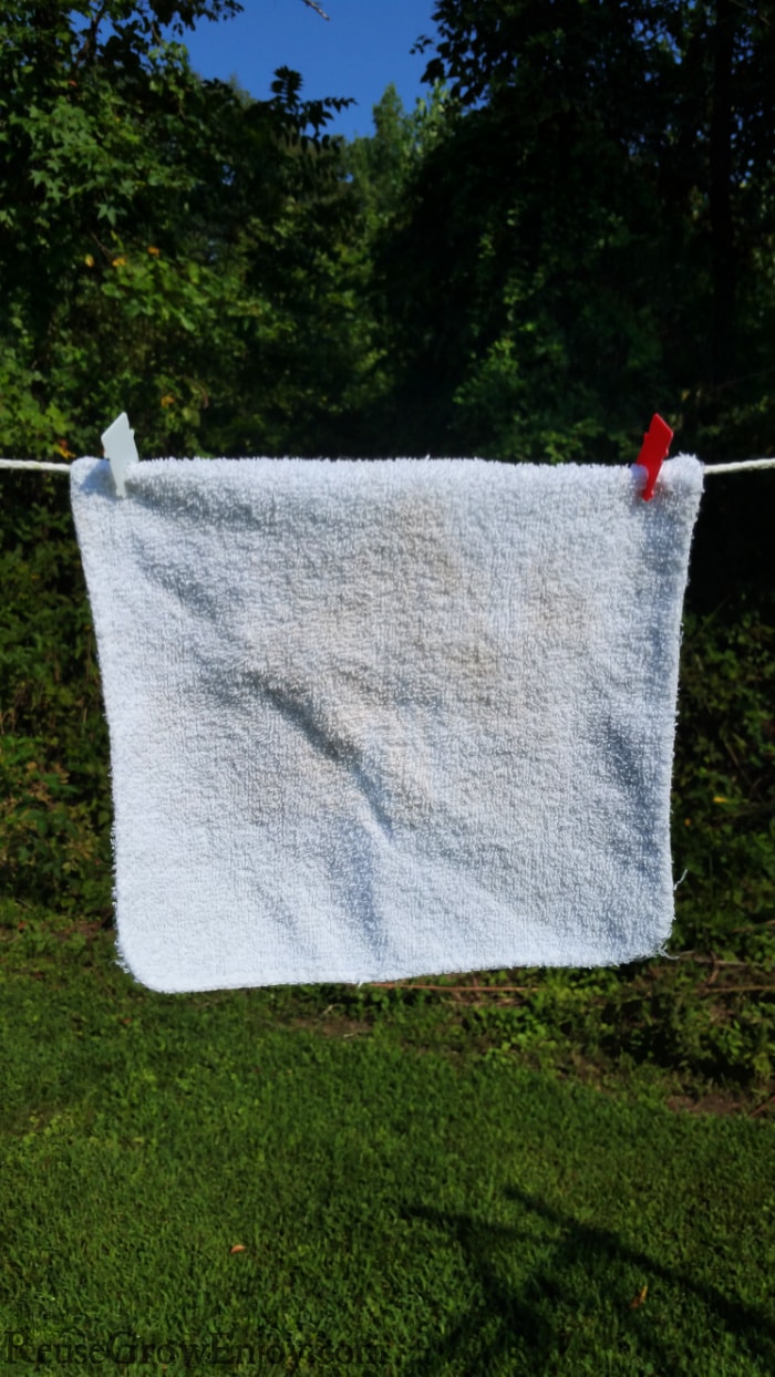 bread clips being used as clothespins to hold washcloth